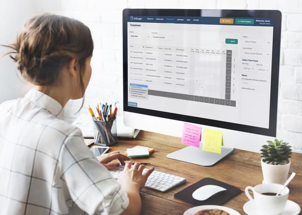 Woman using timesheet InScope software